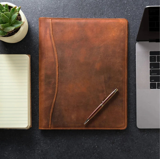 Brown leather padfolio with pen, stitched border and front cover