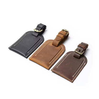 Full grain leather luggage tags with metal buckles, black and brown colors shown.