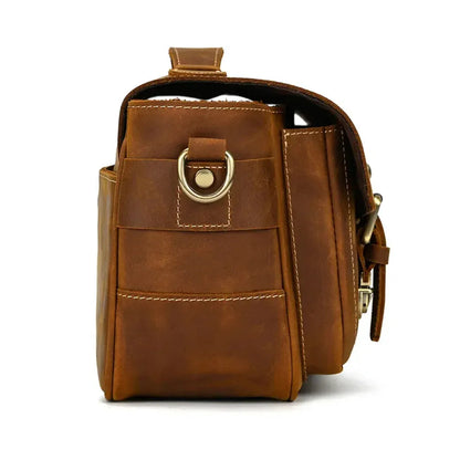 Brown camera messenger bag with front pocket, buckle strap, and crossbody side loop