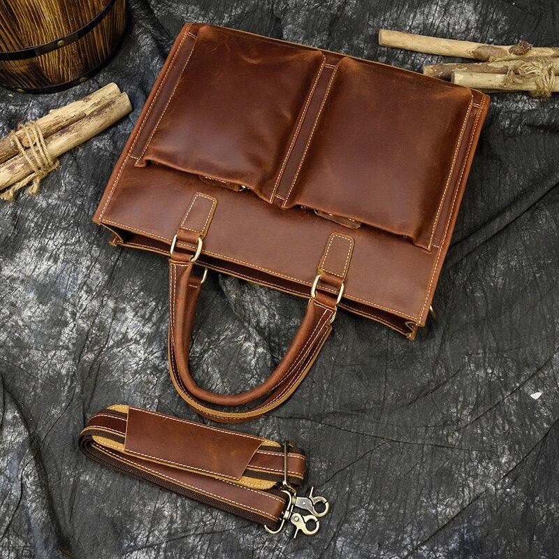 Brown leather messenger bag with flap, two front pockets, and matching long shoulder strap