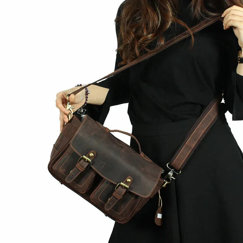 Dark brown camera messenger bag with front buckle straps and adjustable crossbody strap