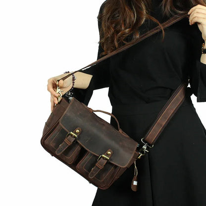 Dark brown camera messenger bag with front buckle straps and adjustable crossbody strap