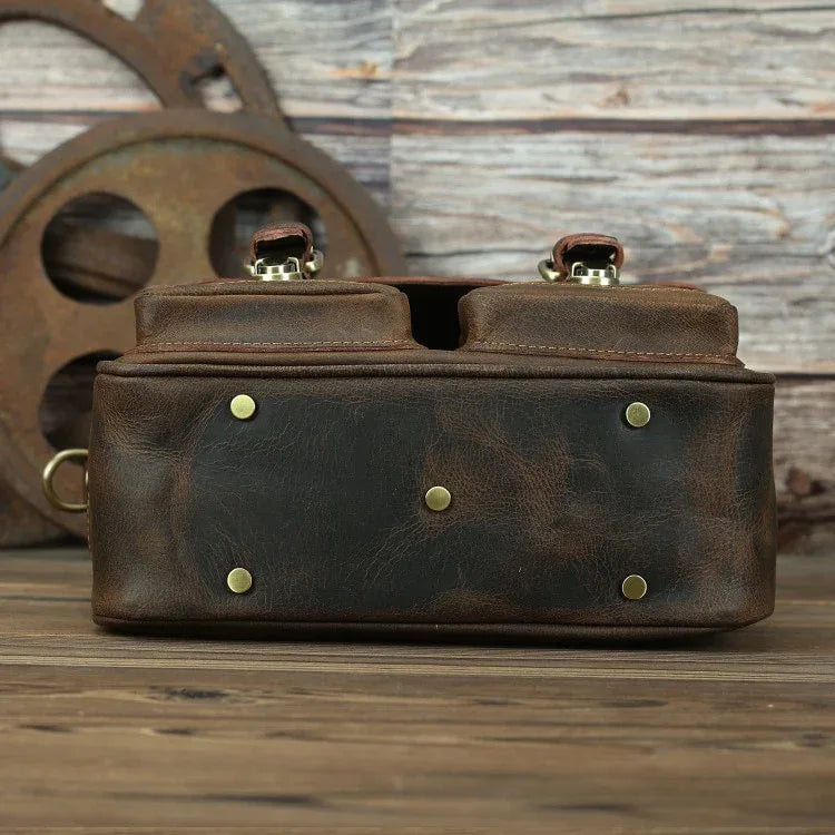 Dark brown vintage camera messenger bag with brass snaps and dual top buckles