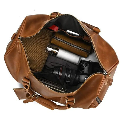 Brown leather duffle bag open top showing inner compartments and side elastic pocket.