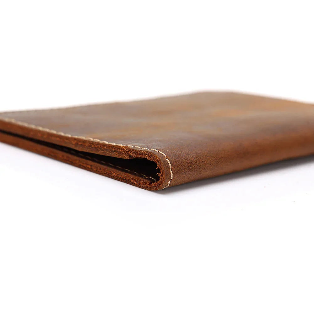 Handmade brown leather passport cover, stitched edge close-up