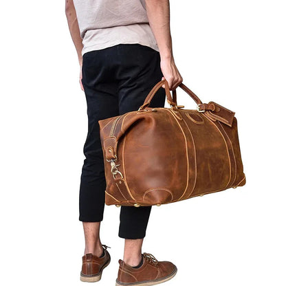 Vintage leather duffle bag carried at hip, brown leather, rounded front pocket.