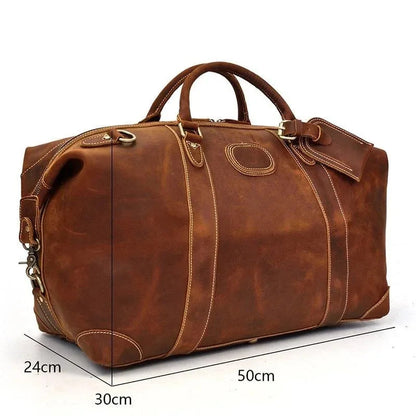 Vintage leather duffle bag with strap and visible dimensions: 50cm x 30cm x 24cm.