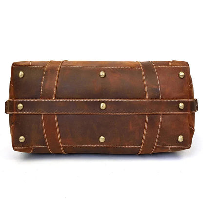 Brown vintage leather duffle bag with front strap and brass stud details