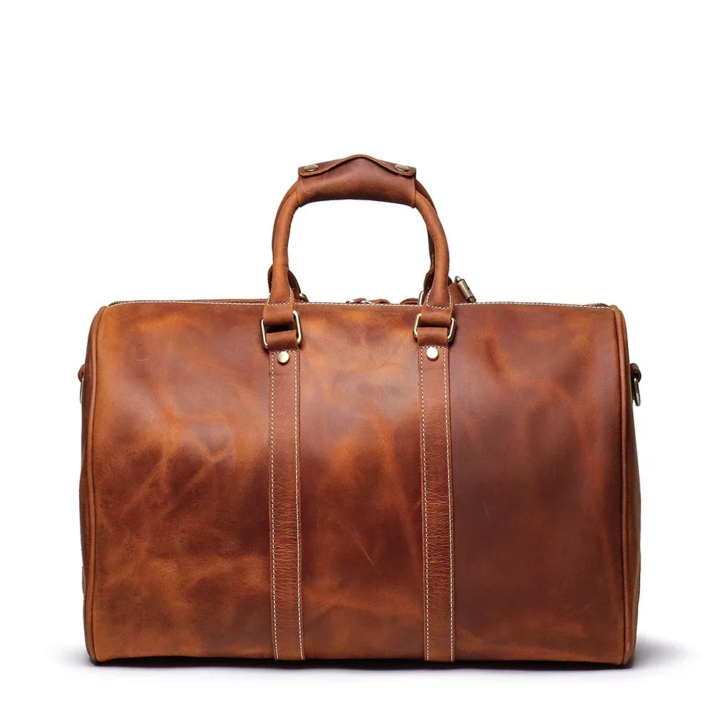 Small brown leather duffle bag with top handles and long center zip front