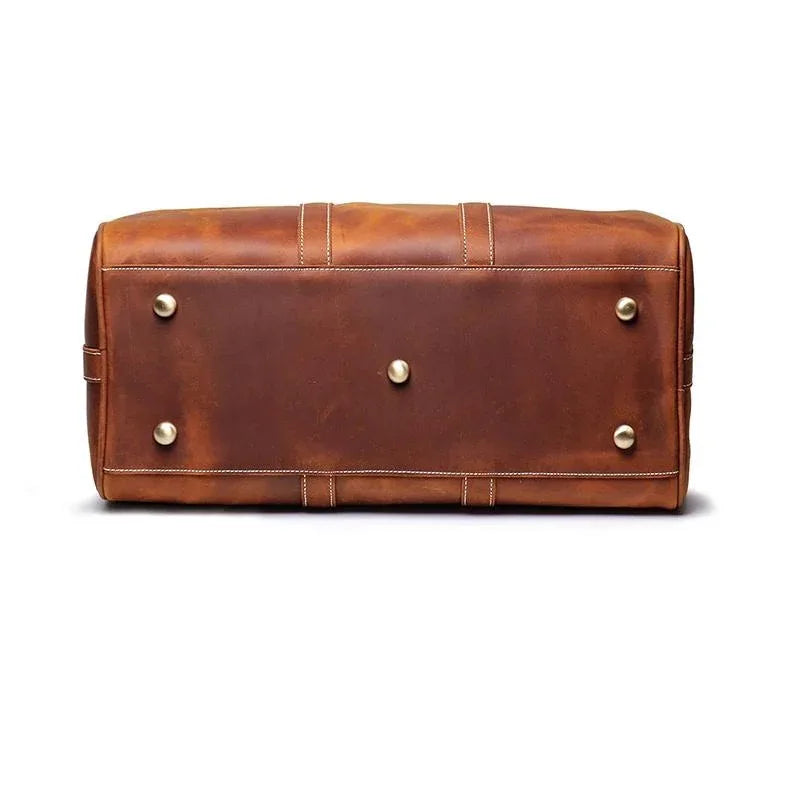 Small leather duffle bag front view, brown with snap hardware and center panel