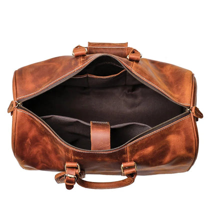 Small leather duffle bag open, dark interior with zip opening and brown straps