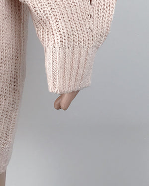 Women's Oversized Turtleneck Sweater pink arm close up of knitting
