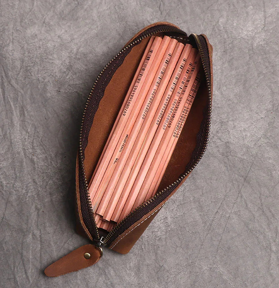 Brown leather makeup pouch with zipper, open interior showing lining and strap