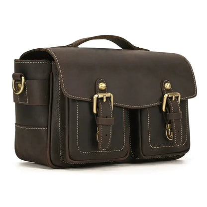 Brown camera messenger bag with flap, side panel, and stitched front strap details
