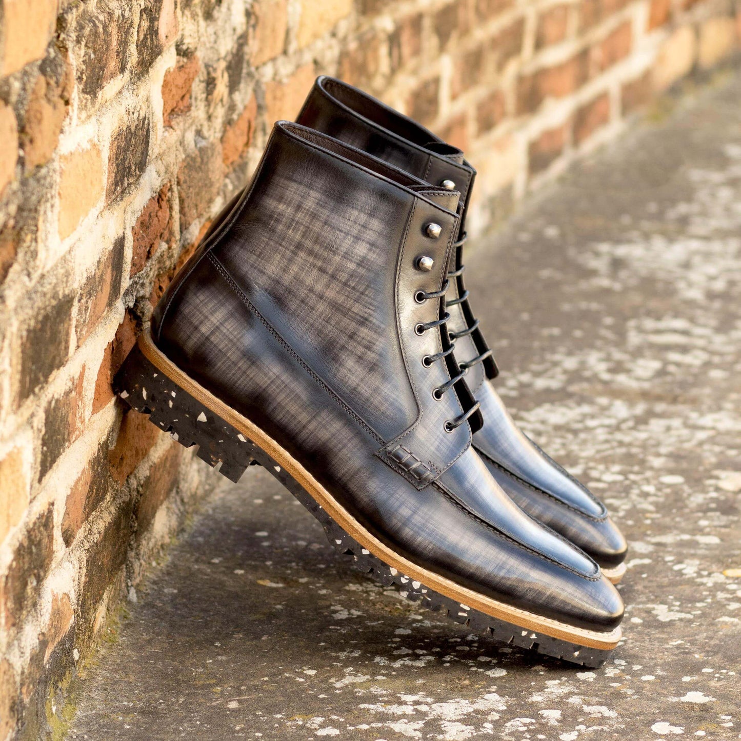 Men's Leather Moc Boots outside pair together against a wall