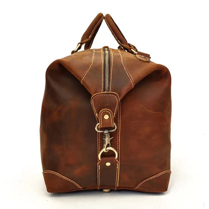 Brown leather duffle bag with top handles, front zipper, and metal clasp