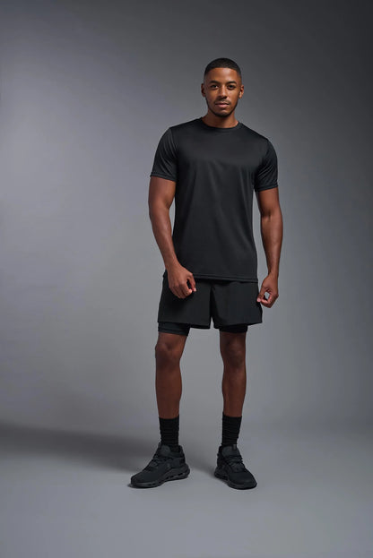 Man wearing a black athletic outfit on a gray background