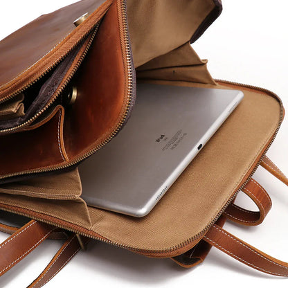 Small leather backpack open front pocket holding a tablet