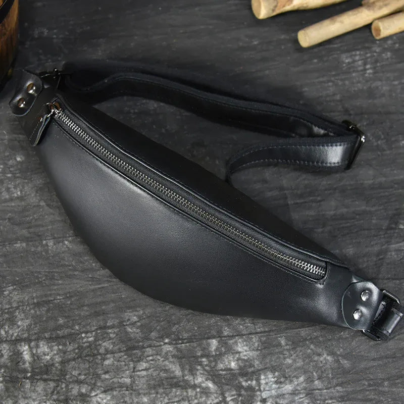 Black leather fanny pack side view with front zipper and waist strap