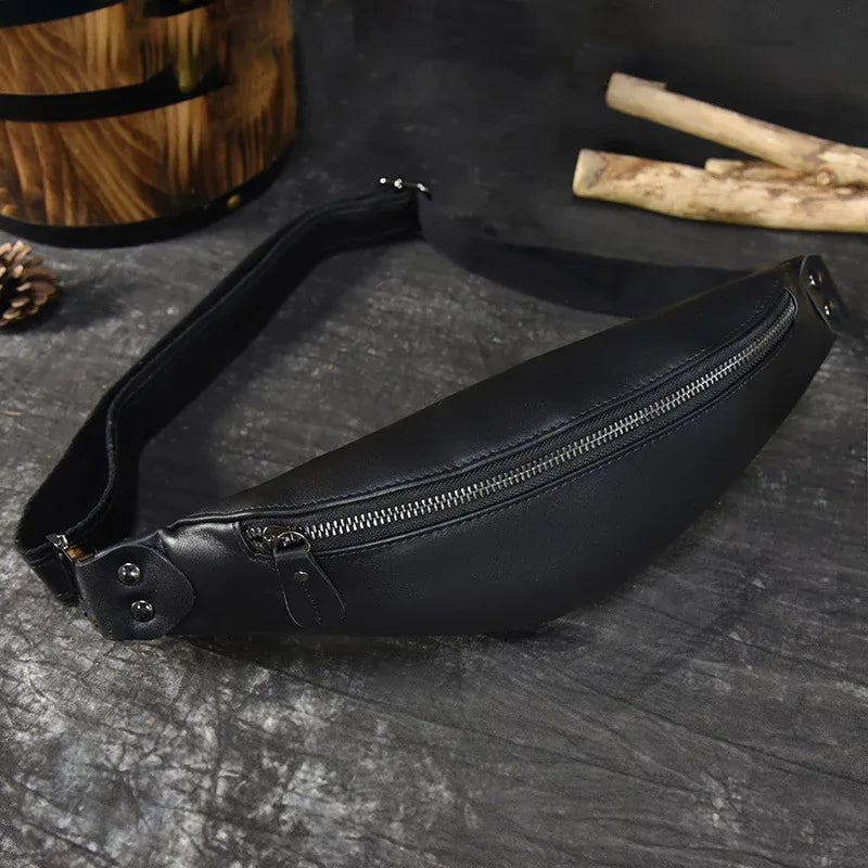 Black smooth leather fanny pack with front zipper and adjustable shoulder strap.