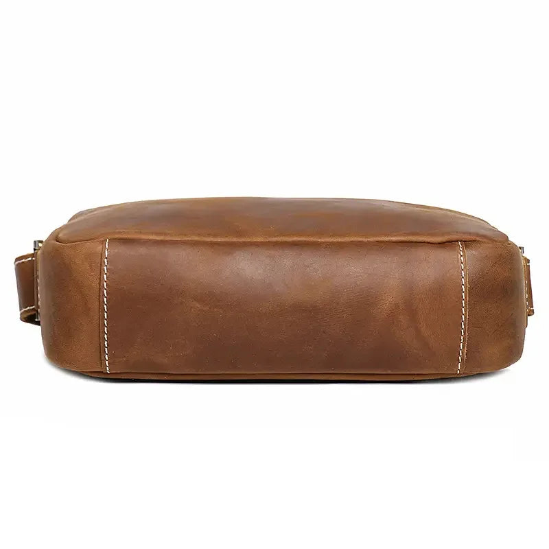 Brown leather crossbody bag bottom view with rounded base and stitched edge seams