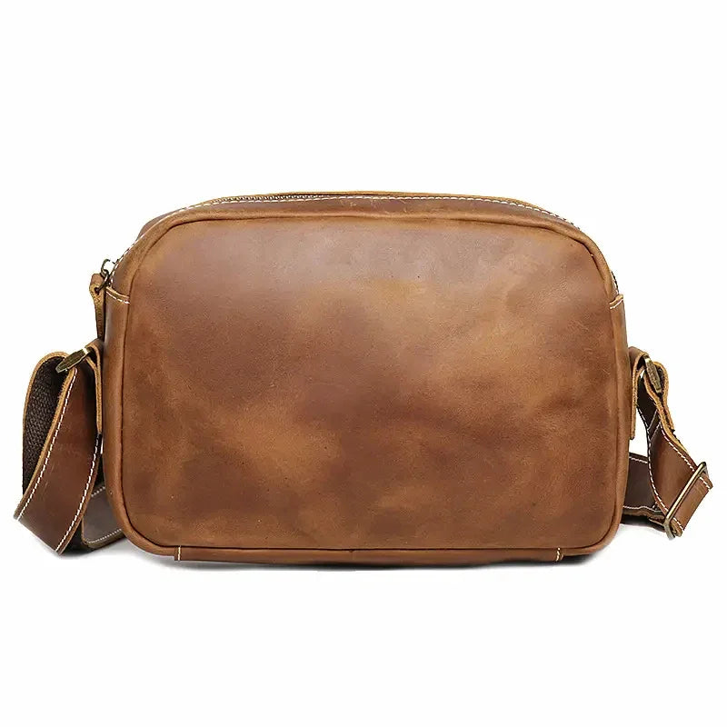 Brown leather crossbody bag with top zipper and adjustable shoulder straps