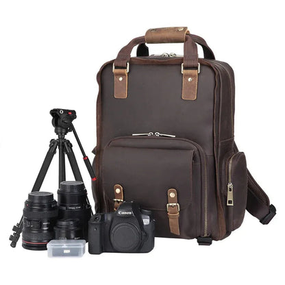 Dark brown leather camera backpack with top handle and front tripod holder