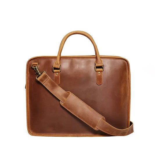Vintage leather briefcase with top handles, front strap and metal hardware in brown