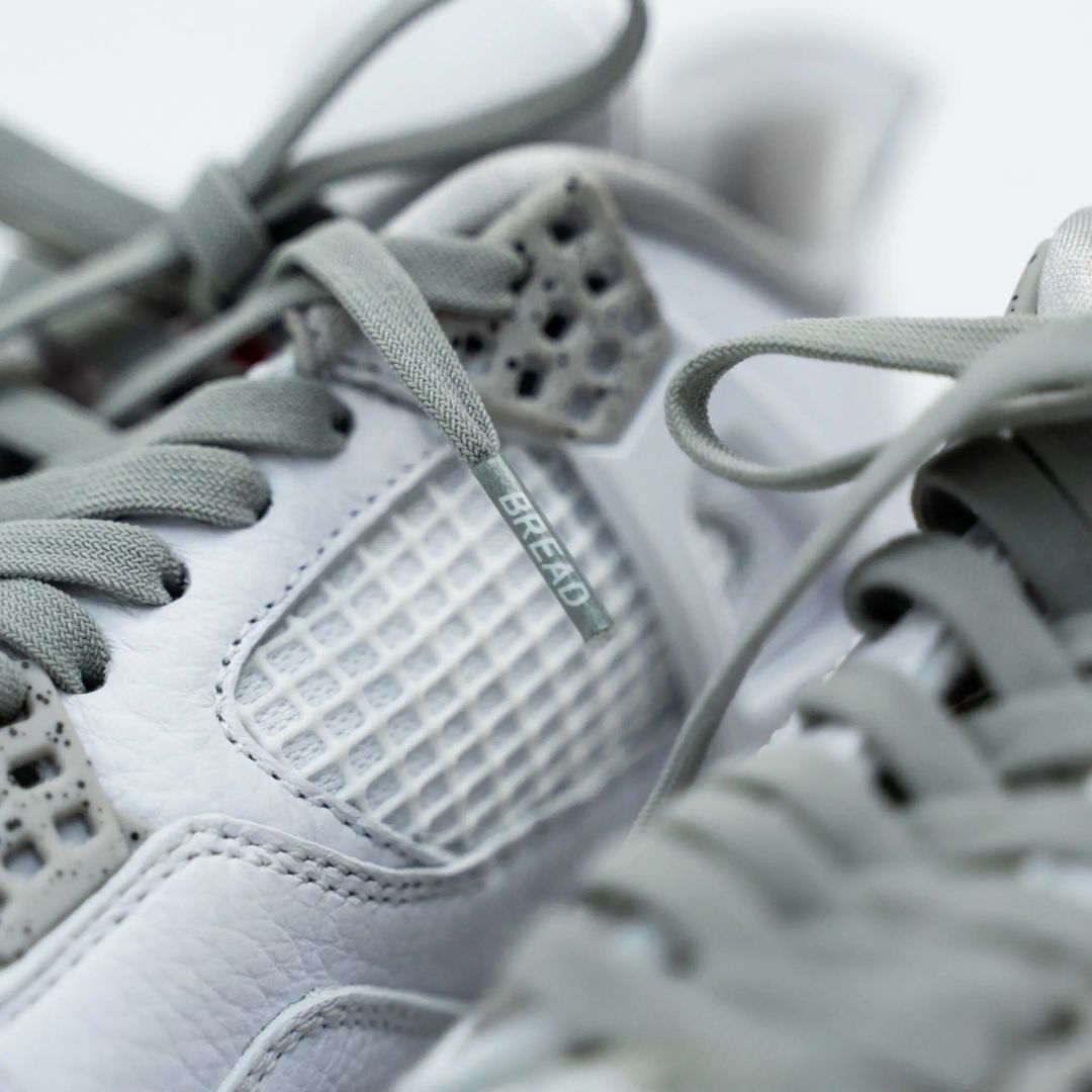 Close-up of gray sneakers with 'Bread' branding on a blurred background