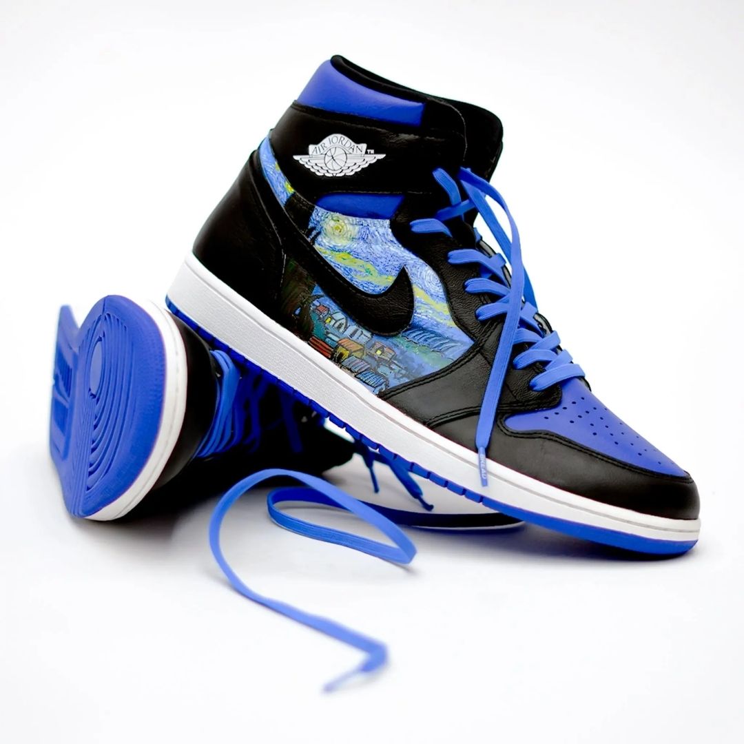 Black and blue high-top sneakers with a colorful pattern on a white background