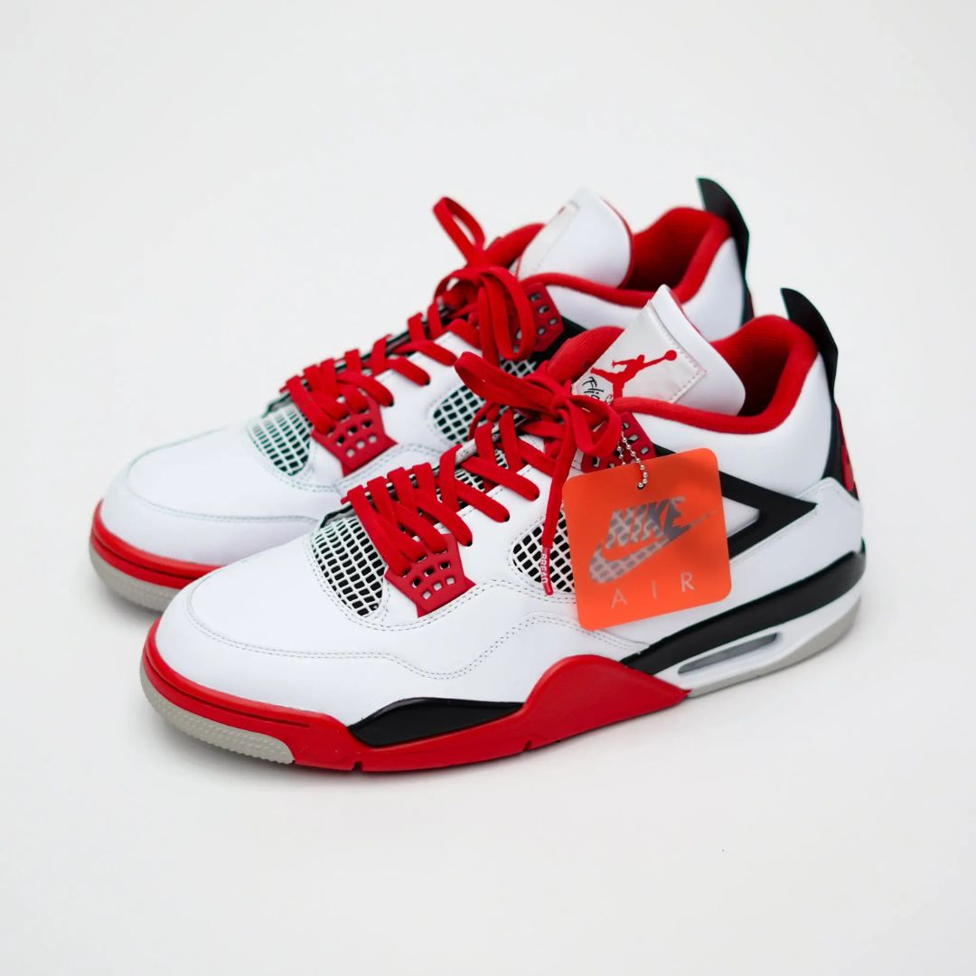 White sneakers with red and black accents on a white background