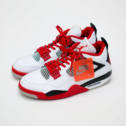 White sneakers with red and black accents on a white background