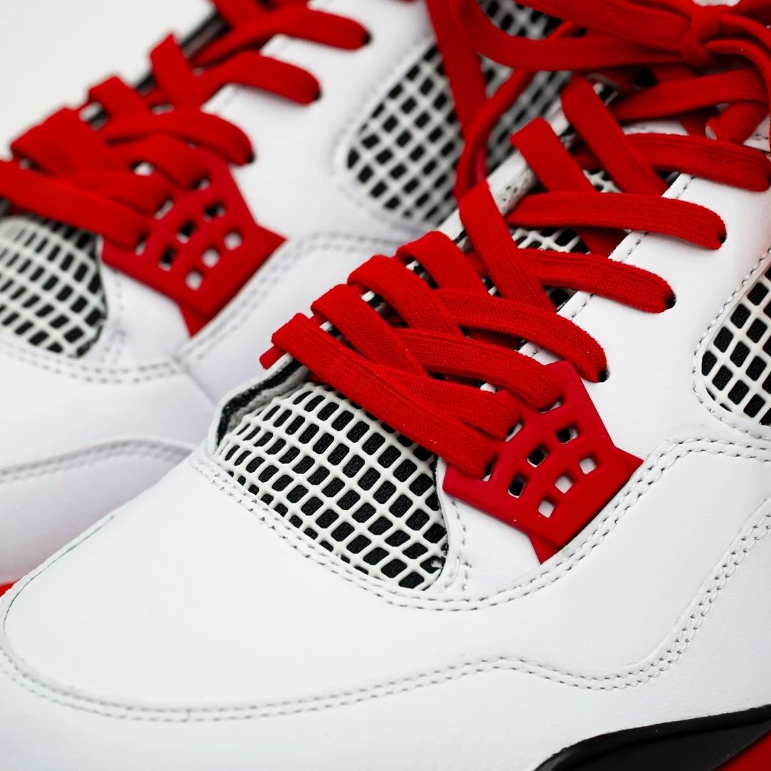 White sneakers with red laces and text on a white background