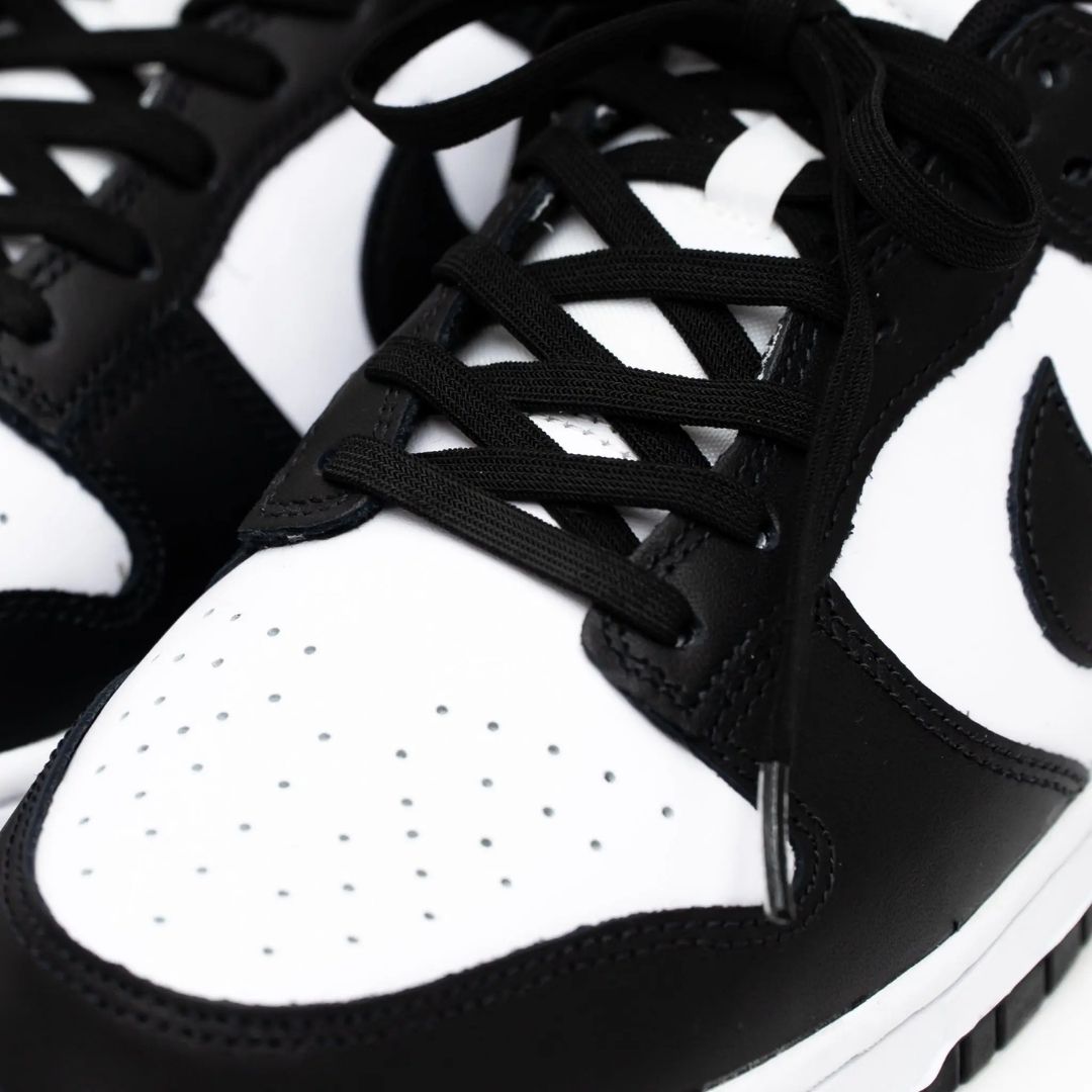 Close-up of black and white sneakers with laces