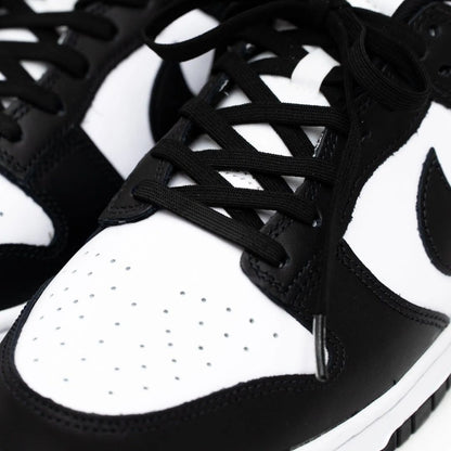 Close-up of black and white sneakers with laces