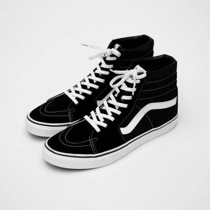 Black high-top sneakers with white laces on a light gray background
