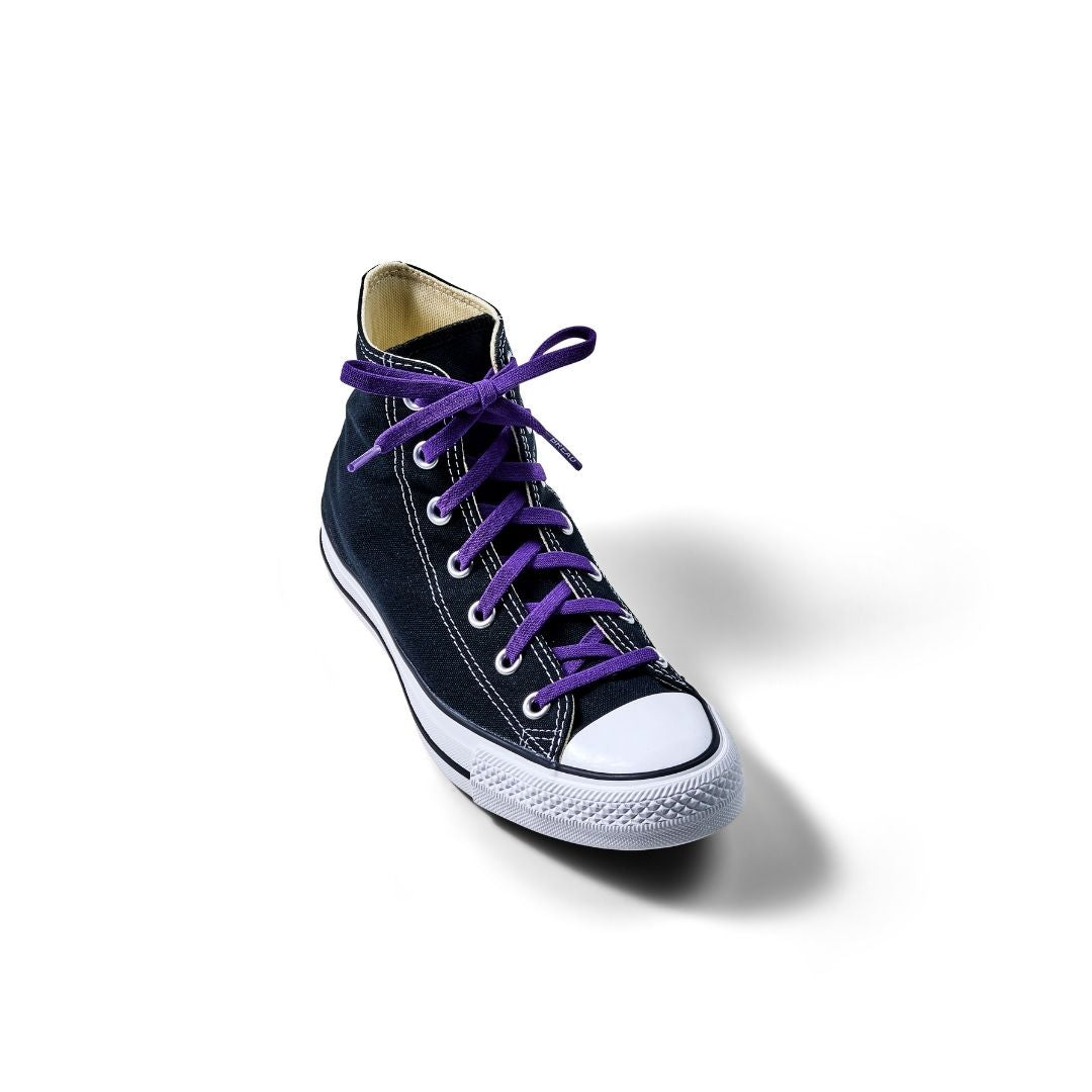 Black high-top sneaker with purple laces on a white background