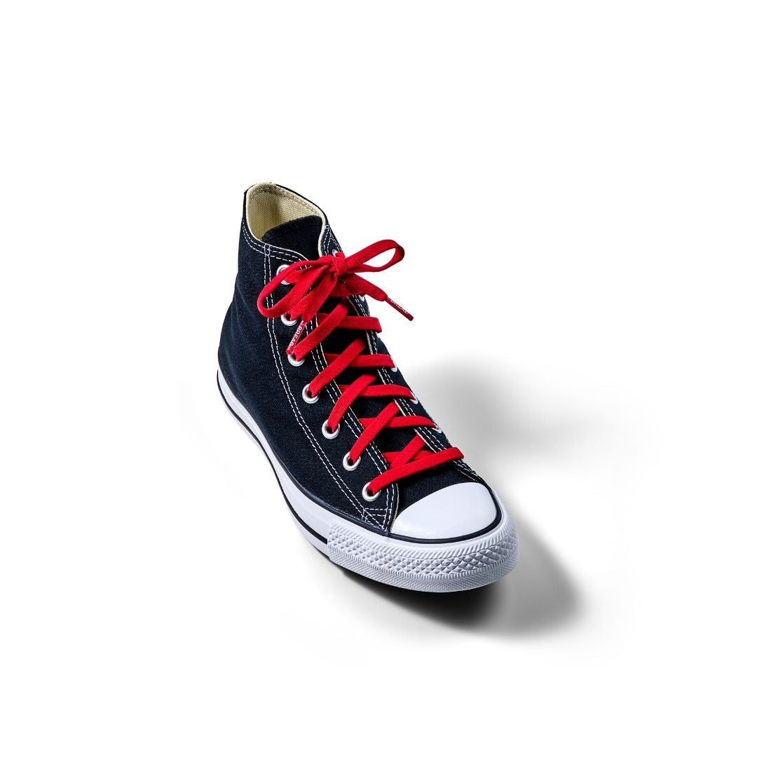 Black high-top sneaker with red laces on a white background