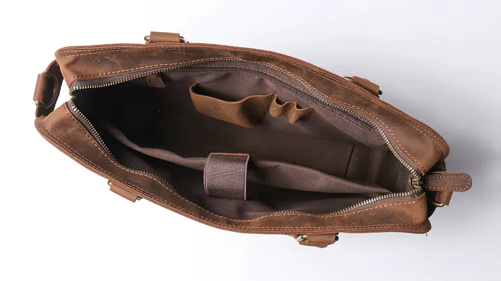 Brown leather messenger bag interior with zip pocket and organizer compartments