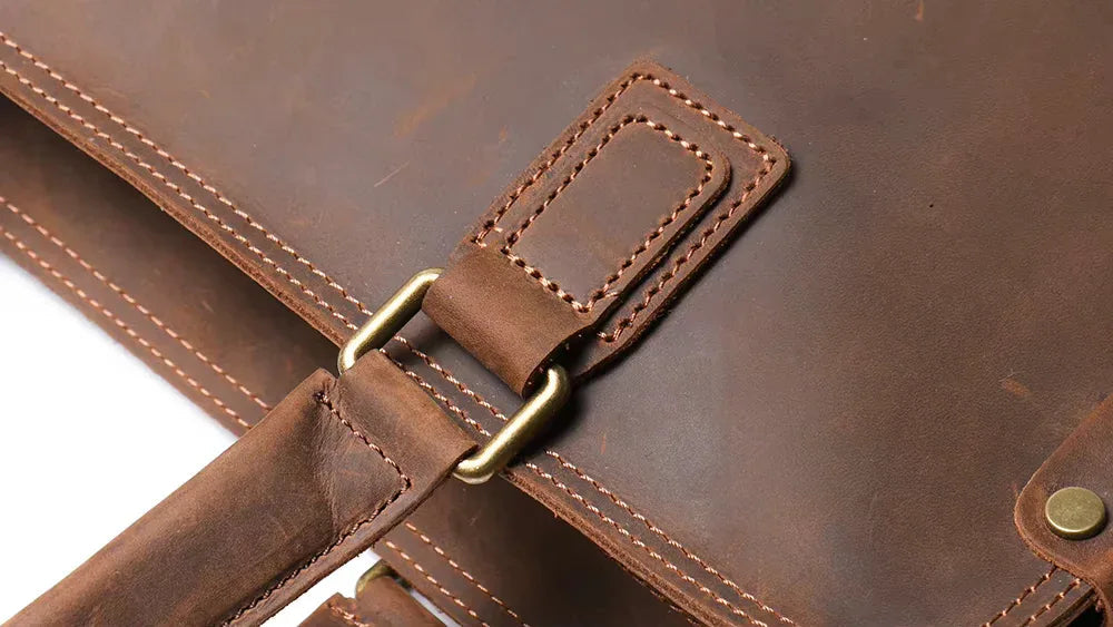 Brown leather strap with brass roller buckle and stitched attachment tab
