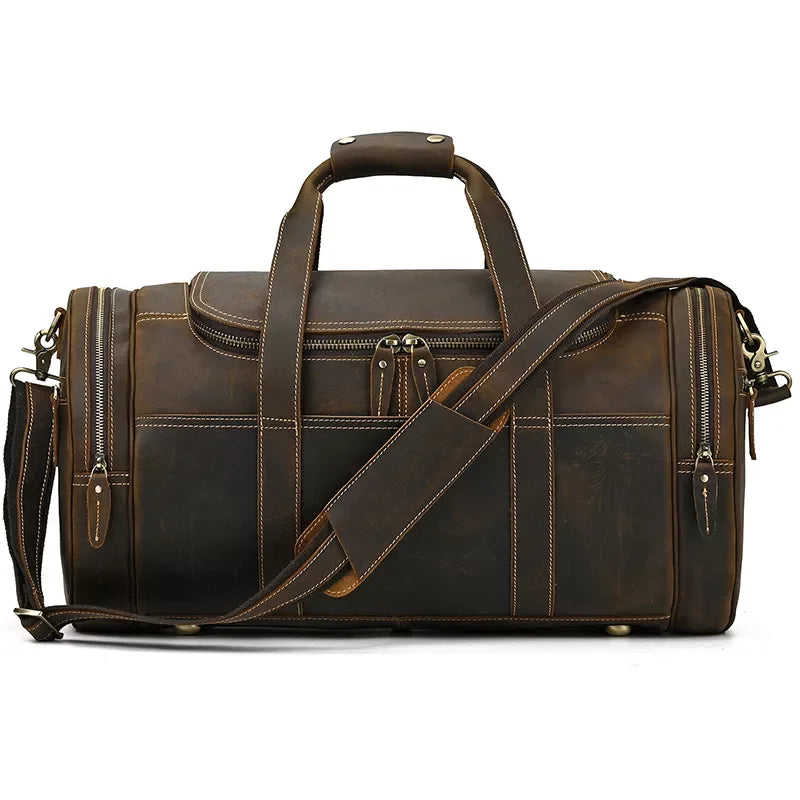 Brown leather weekender duffel bag with top handle, crossbody strap, and two zip end pockets.