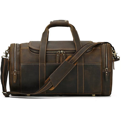 Brown leather weekender duffel bag with top handle, crossbody strap, and two zip end pockets.