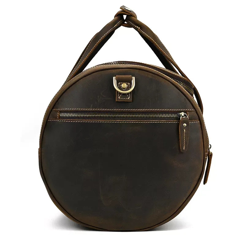Round vintage leather weekender duffle bag with top handle and front zip pocket