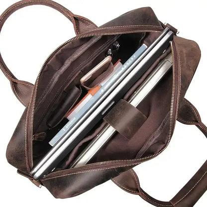 Vintage leather messenger bag open view showing multi-slot organizer and zipper pocket interior