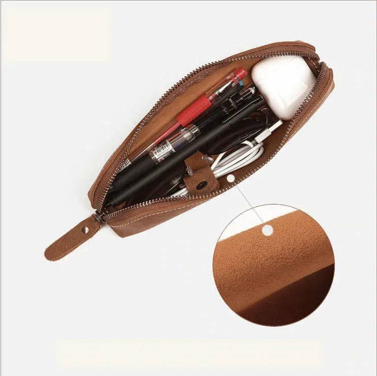 Brown leather makeup pouch with zipper, showing makeup inside