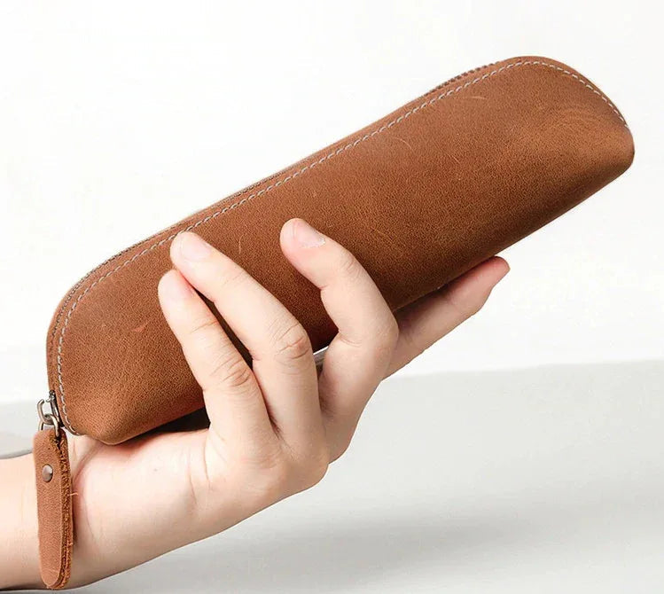 Brown leather makeup pouch with zipper and wrist strap