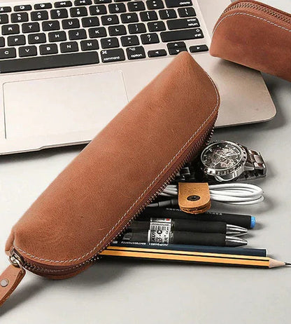 Brown leather makeup pouch with zipper closure and wrist strap