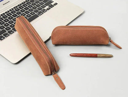 Brown leather makeup pouch with long zipper and wrist strap