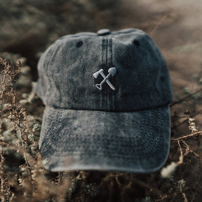 Denim cap with embroidered design on a natural background
