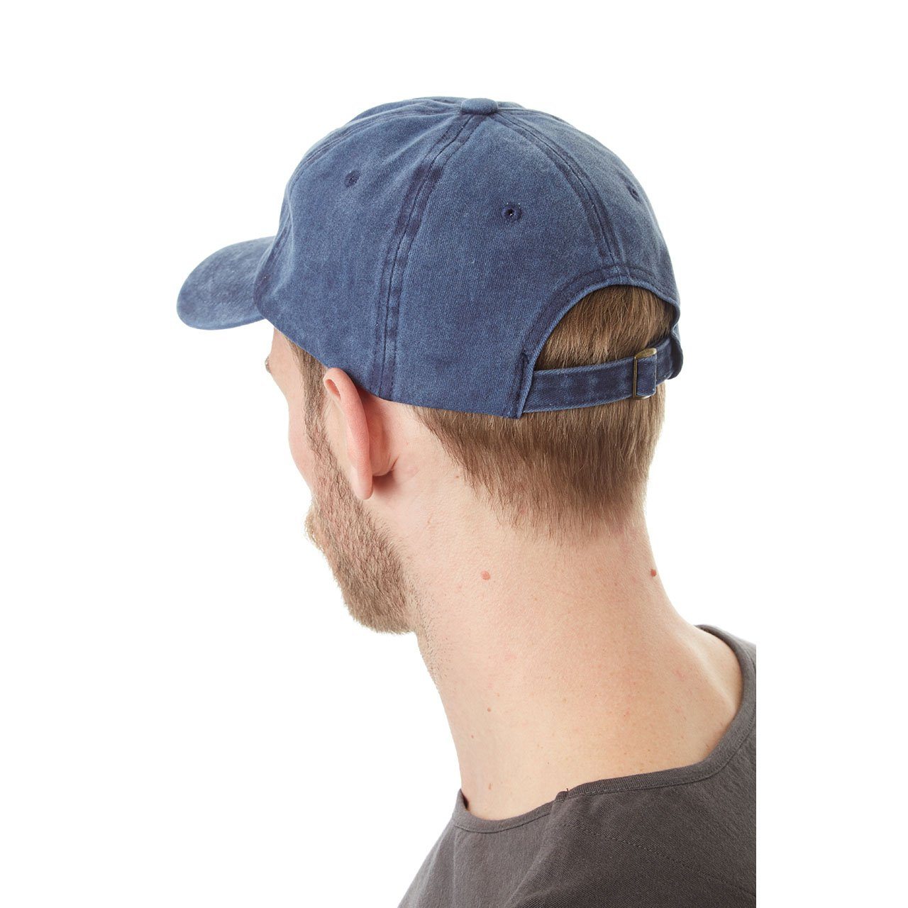 Blue baseball cap worn by a person on a white background